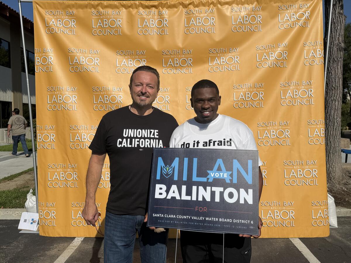 Milan Balinton and a supporter in a Unionize California shirt hold a campaign sign