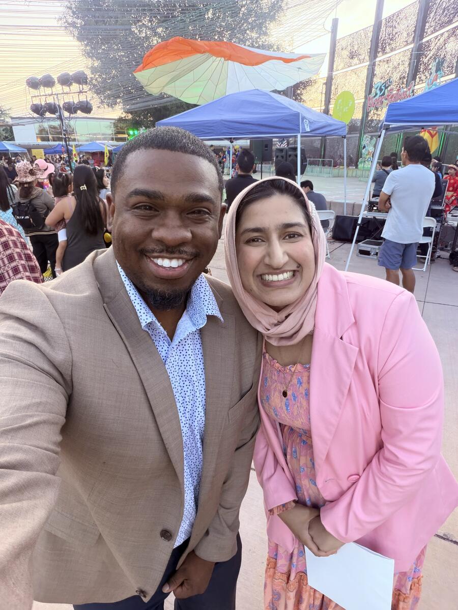 Milan Balinton takes a selfie with a supporter at an outdoor community festival