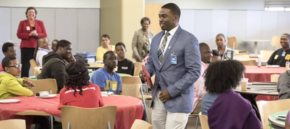 Mr. Milan Balinton, giving out laptops to the kids in a program for their benefit.